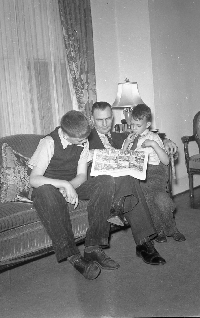 Family friend reading comics. Boys may be Walter White and Lewis Dove.